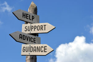 Signpost with signs showing Help, Support, Advice and Guidance