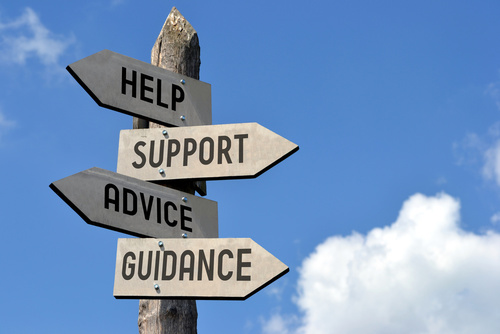 Signpost with signs showing Help, Support, Advice and Guidance
