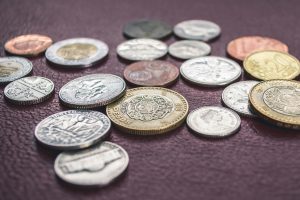 Coins from different currencies on a flat surface.