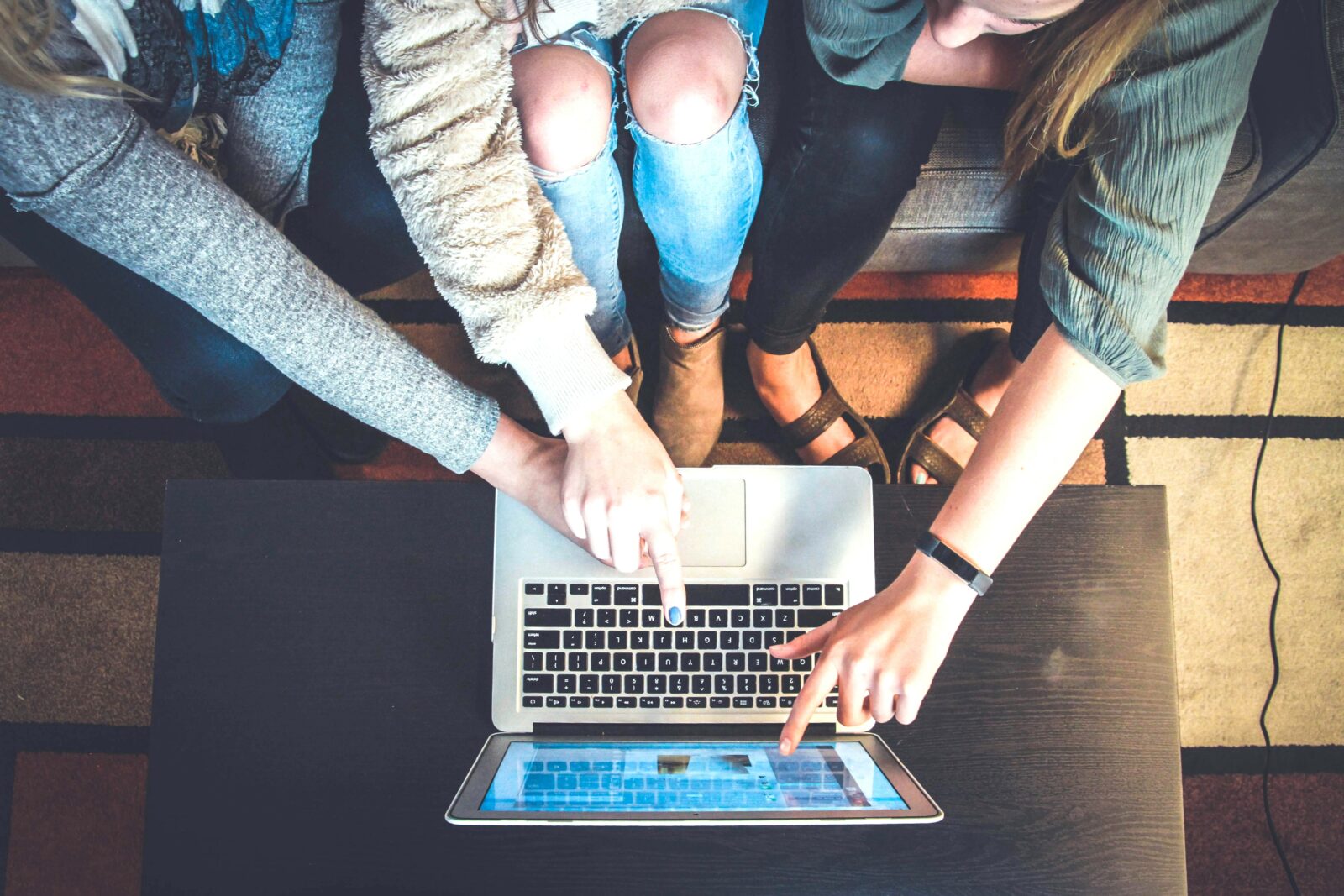 Young people looking at a laptop